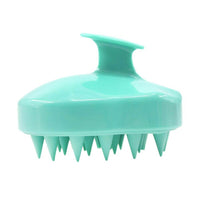 Brosse à shampoing bleu avec picots en silicone pour un massage doux du cuir chevelu