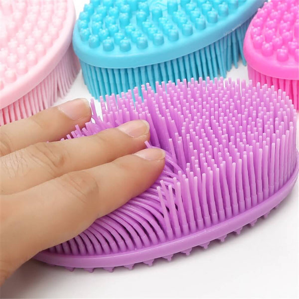 Main appuyant sur les picots de la brosse sensorielle violette, montrant la souplesse du silicone