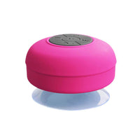 Enceinte portable waterproof rose avec boutons de commande intégrés, conçue pour une utilisation pratique dans toutes les conditions.