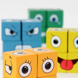 Gros plan sur deux cubes orange illustrant des yeux et des expressions, avec d’autres cubes colorés (bleu et vert) en arrière-plan